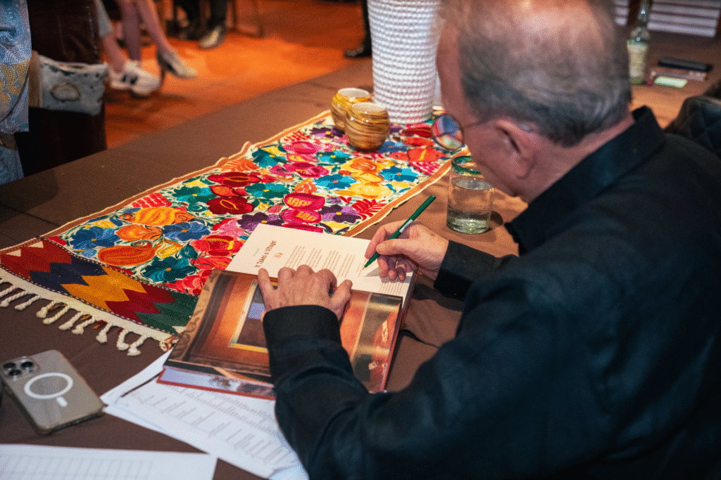 Tom Gilliland signs copies of his book at Fonda San Miguel