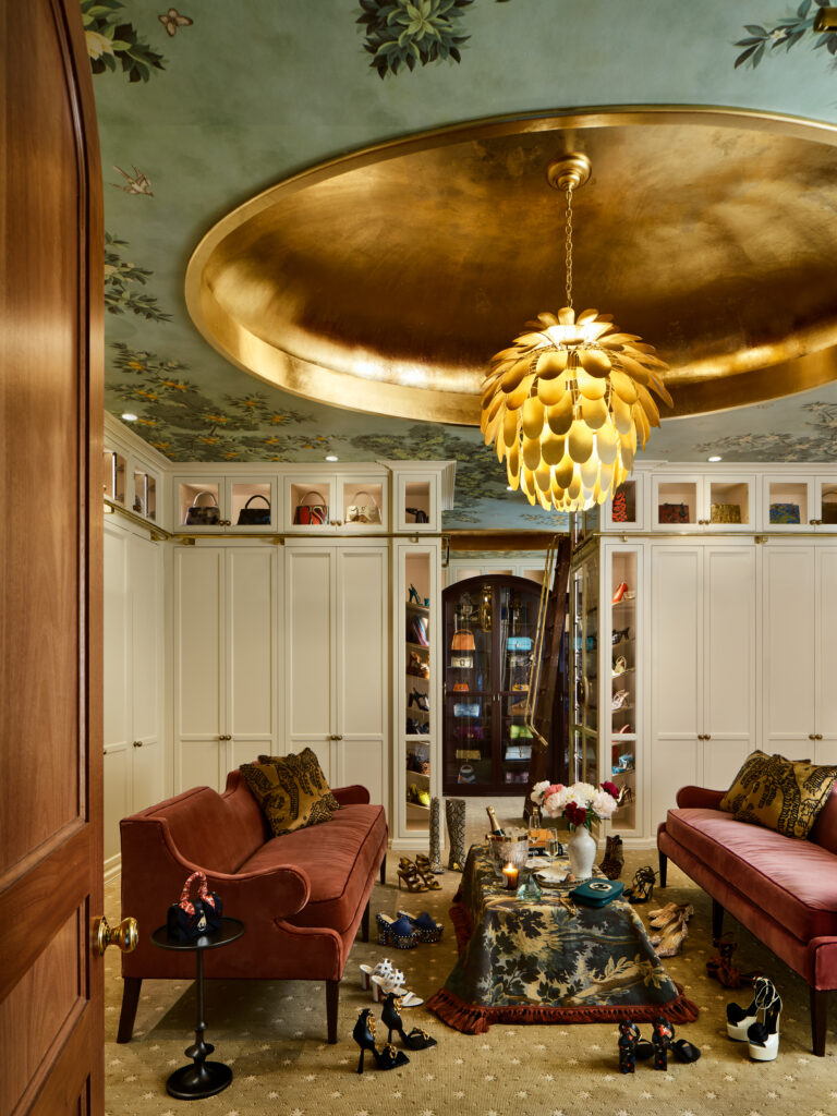 The closet designed by Sarah Stacey features a soft pink velvet seating area, burl wood vanity, fabric-backed wool cabinets and an Art Deco–inspired curio.