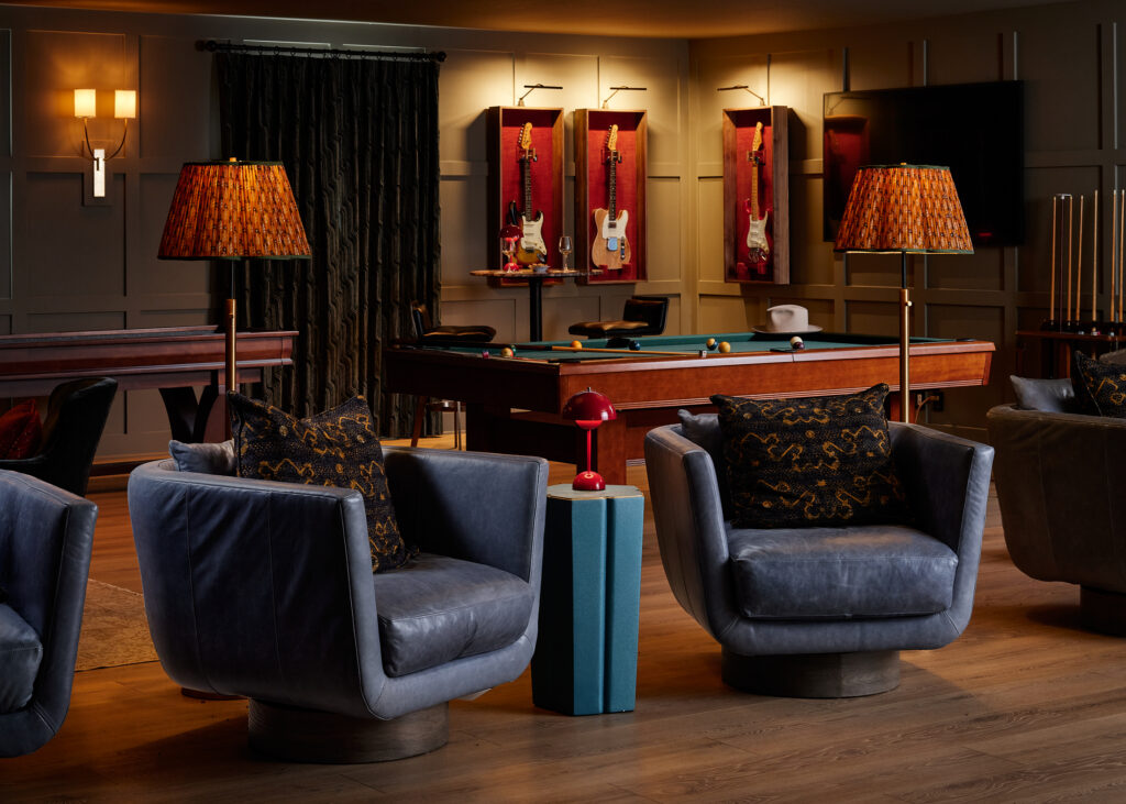 A cozy entertainment room showcases a framed guitar once played by Jimi Hendrix.