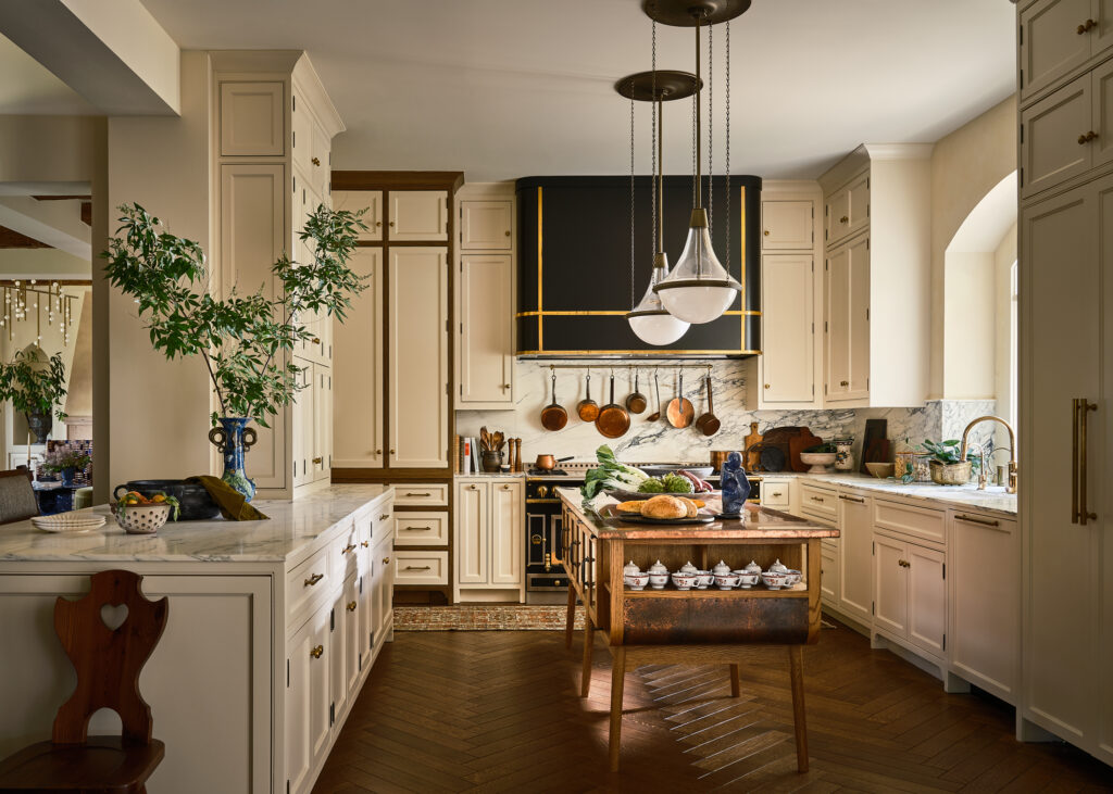The kitchen features a La Cornue range, deVOL island and Urban Electric pendants.