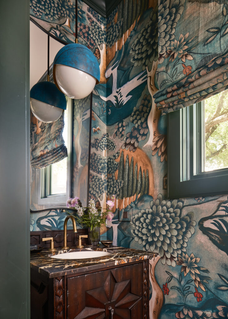 Artful wallpaper brings character to the bathroom.