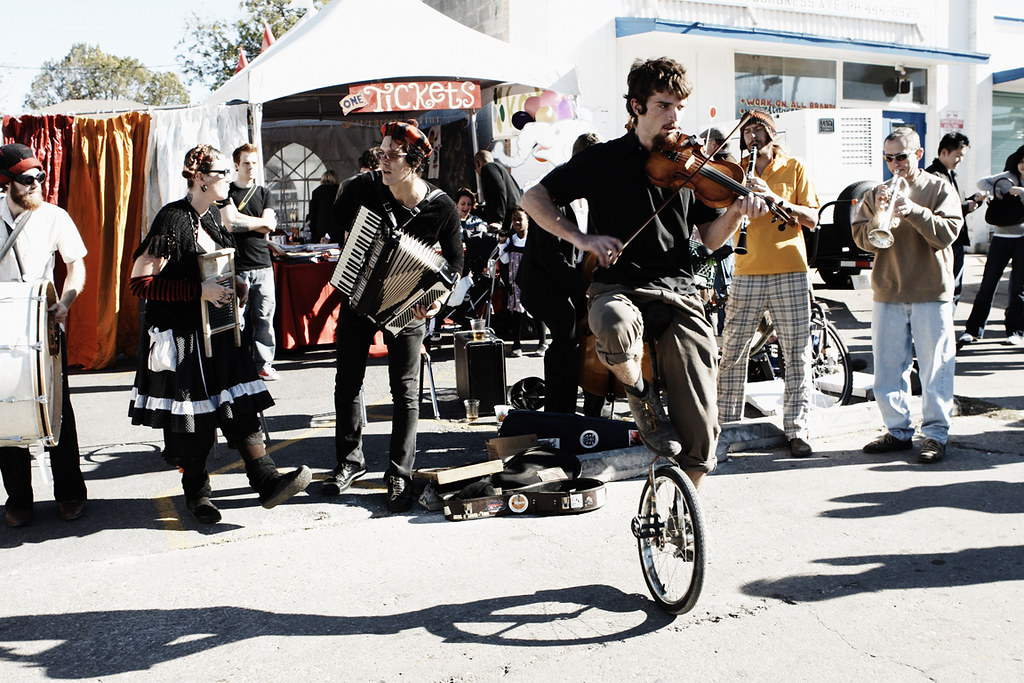 A unicyclist plays the violin during Home Slice Pizza’s Carnival O’ Pizza in 2008.