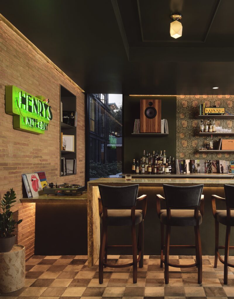 Guests can unwind at Henry’s bar, a cozy space named after John Henry Faulk. (Photo by Casey Dunn)