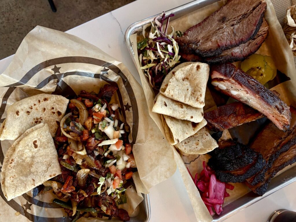 Barbecue plates loaded with brisket, ribs, tortillas and sides from Churchrow Tejas BBQ, which opened Oct. 22 in Austin.