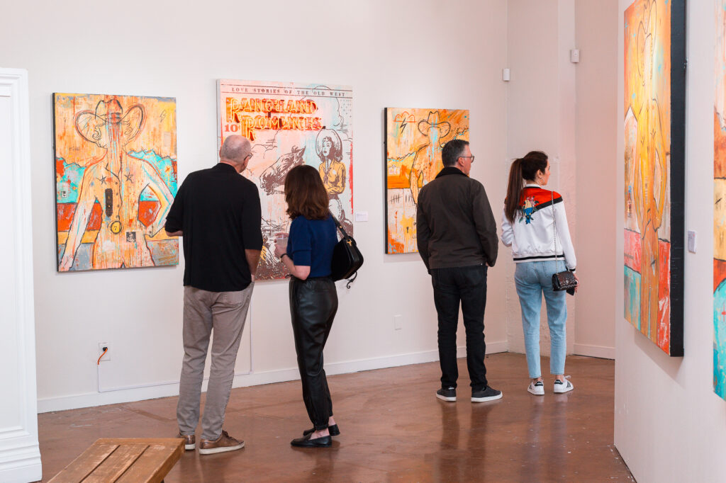 Guests view artwork during the “Beyond the West” public reception at West Chelsea Contemporary. (Courtesy of West Chelsea Contemporary)