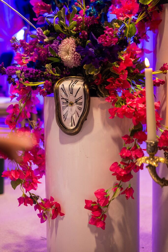 melting clock and flowers as part of the gala's decor