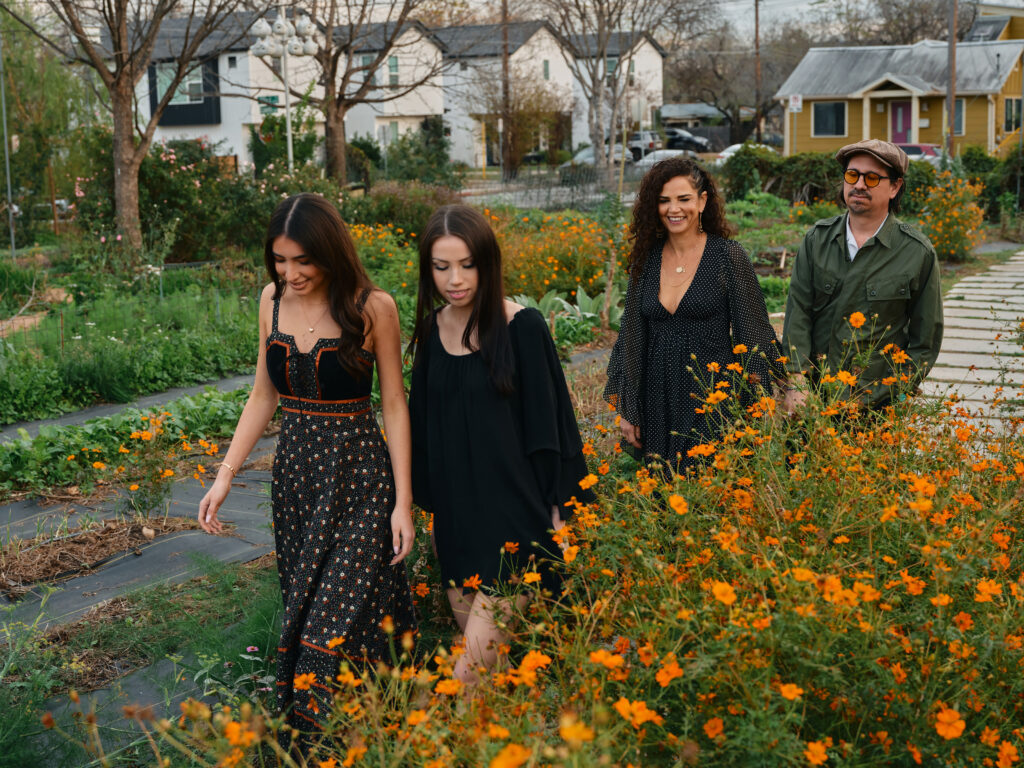 Celeste and Adrian Quesada walk with their children through Este Garden in Austin, Texas. (Photo by Cass Klepac)