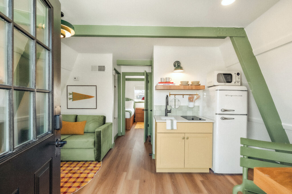A redesigned cabin at Petit Cowboy in New Braunfels features colorful interiors and a nostalgic summer camp feel following French Cowboys’ renovation of the former Heidelberg Lodges. (Photo courtesy of Taylor Bennett & Hunter Mitchell)