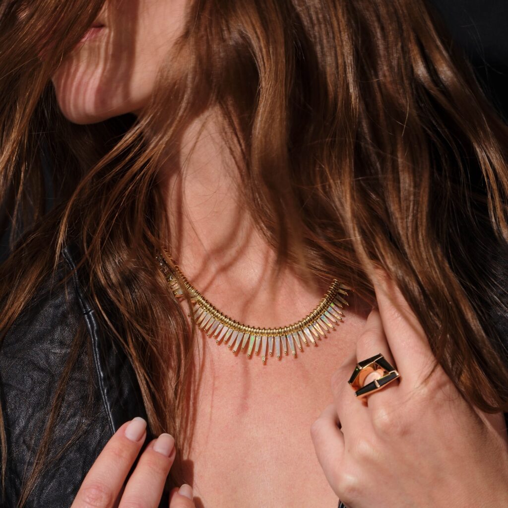 Nak Armstrong serrated necklace in opal, diamond and 18K gold, worn with the brand’s chrome tourmaline fold-over ring.