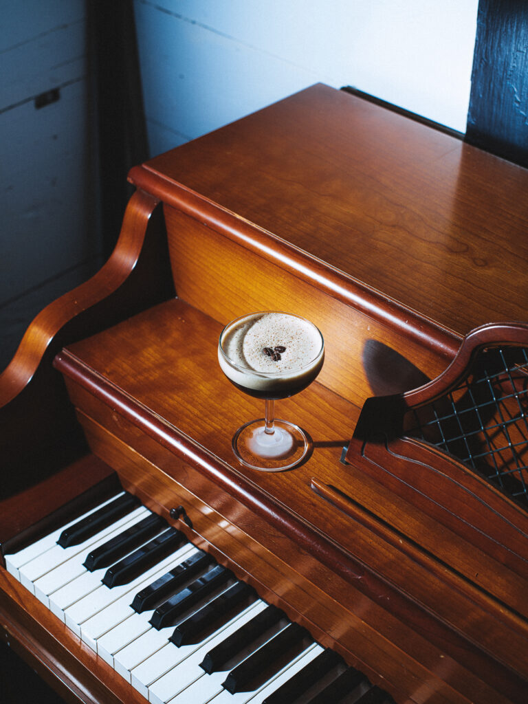 An espresso martini sits on the piano table at Boni’s Bar Next Door in Austin.