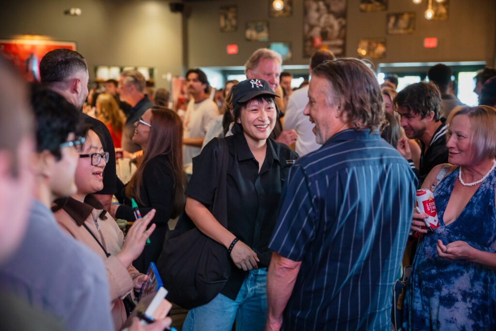 Richard Linklater chats with a guest at the “Everybody Wants Some!!” 10th anniversary screening. (Photo by Lauren Slusher)