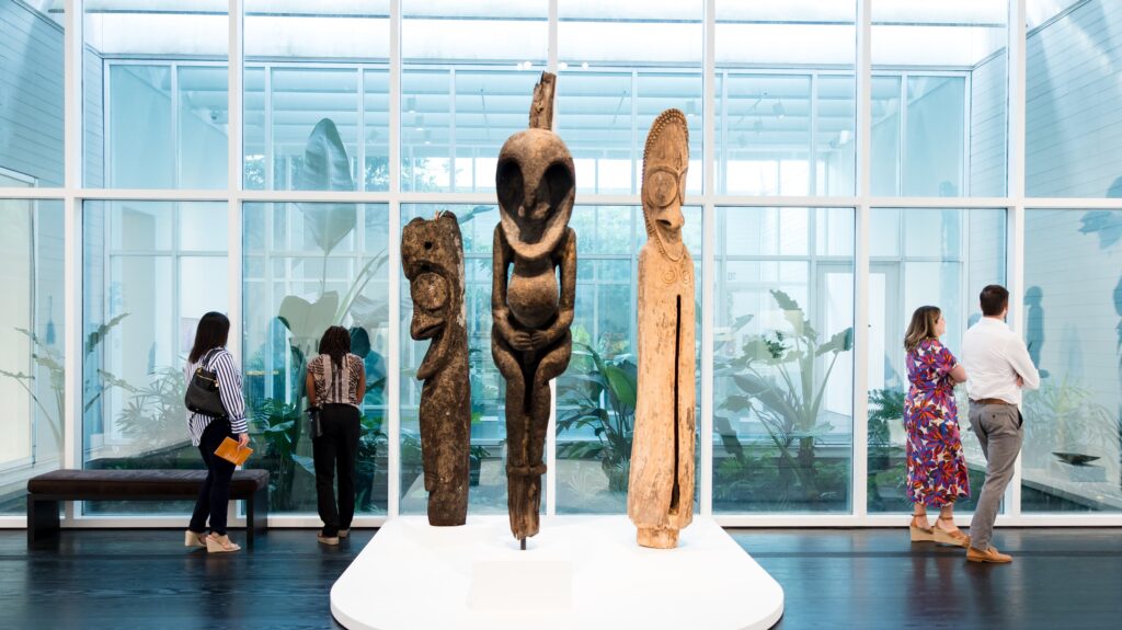 Patrons of the arts viewing works and large sculptures at The Menil in Houston, Texas.