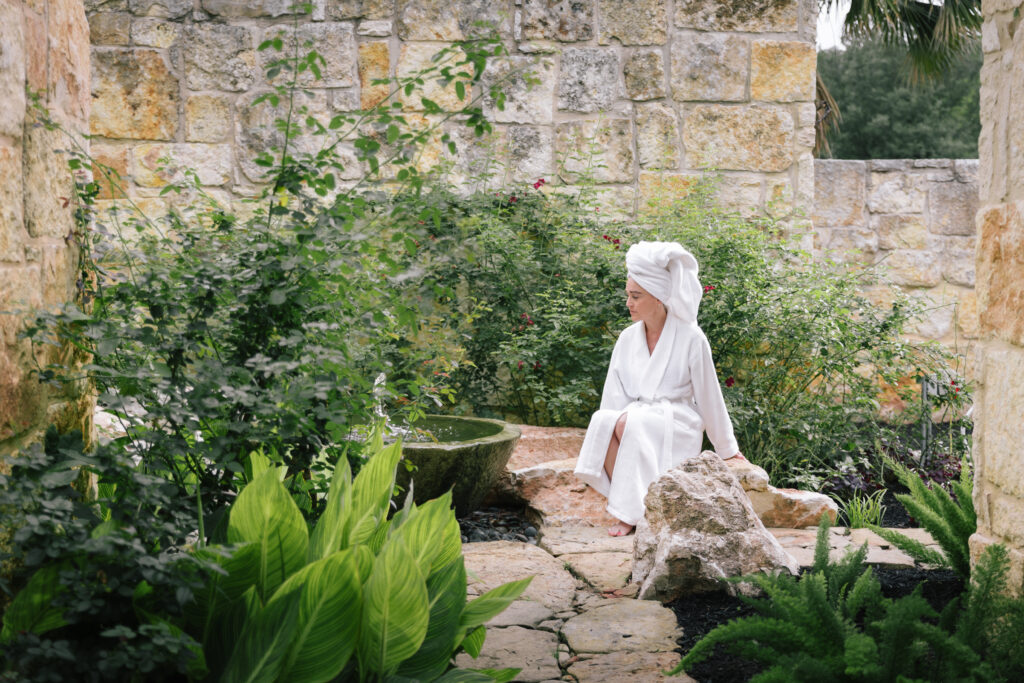 woman sitting in garden of Lake Austin Spa Resort