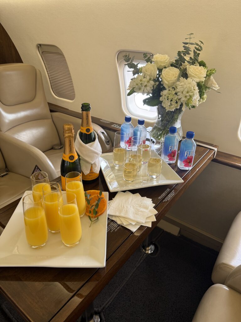 mimosas and flowers inside a private jet