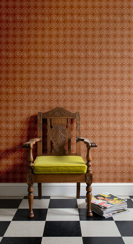 "Fair Day" wallpaper in a room with an antique chair.
