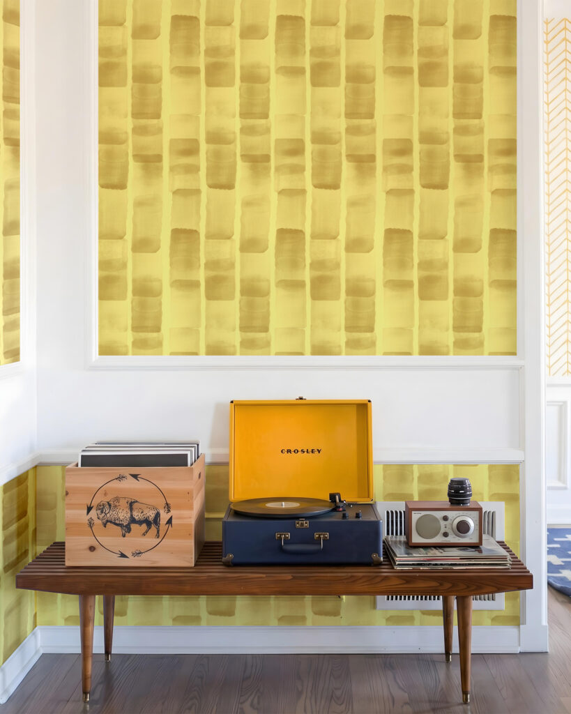 bright yellow wallpaper with a record player in a corner of a room.