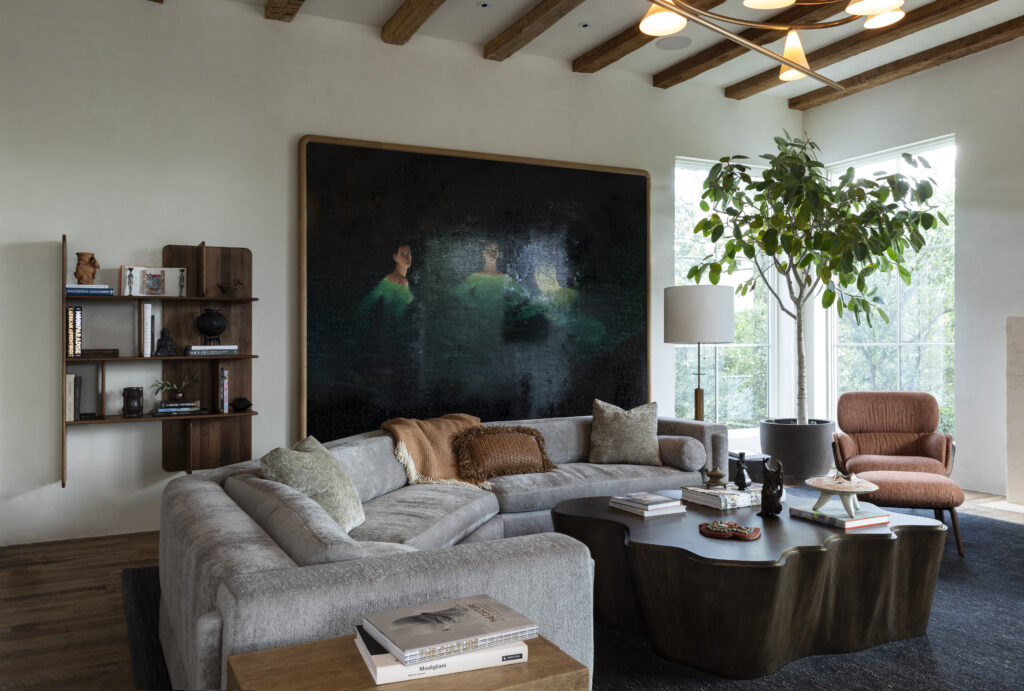 The living room of a Tarrytown home redesigned by Mark Cravotta of Cravotta Interiors features reclaimed wood floors, exposed beams and custom furnishings.