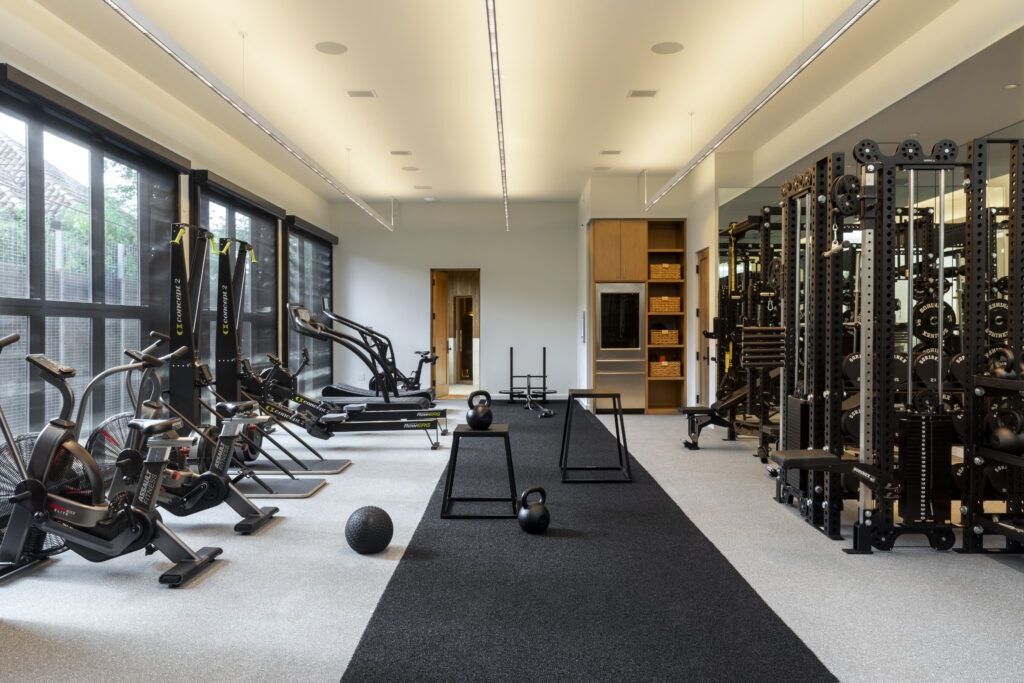 The fitness and recovery space in a Tarrytown home redesigned by Mark Cravotta of Cravotta Interiors includes a sauna, cold plunges and workout area.