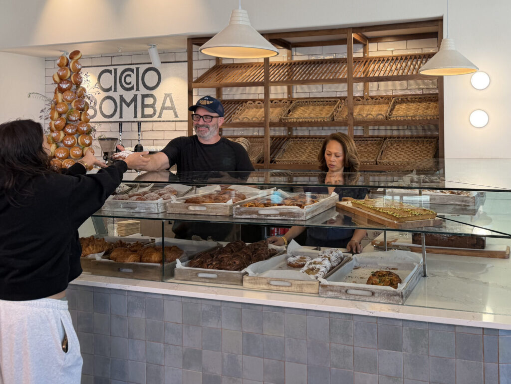 Ciccio Bomba co-owners Tom Segura and Marlo Vinzoni hand out pastries to customers at the cafe’s South Lamar flagship location in Austin