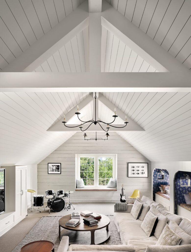 The converted attic lounge serves as a multipurpose gathering space for movie nights, music sessions, sleepovers and family time.