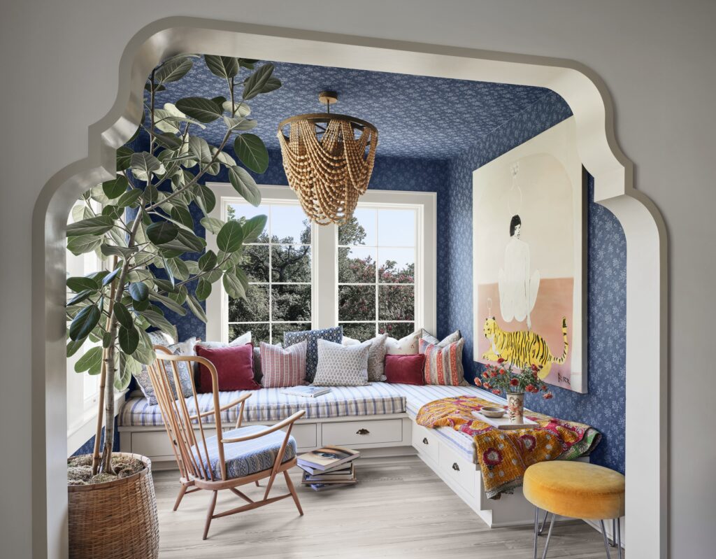 The primary suite lounge in the Judges Hill home provides a cozy retreat, layered with collected furnishings, artwork and personal touches.