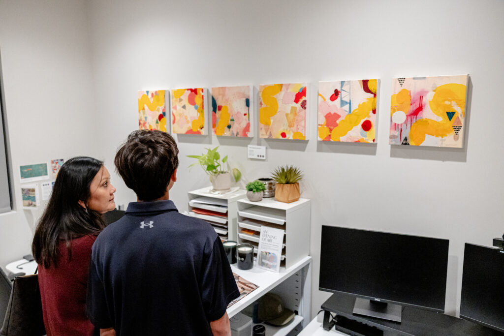 Guests view artwork during Britt Design Group’s annual “Evening of Art” exhibition
