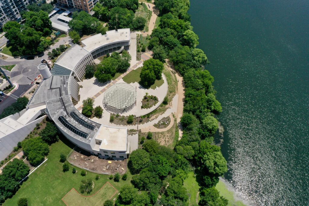 Aerial view of the Emma S. Barrientos Mexican American Cultural Center on the shores of Lake Austin.
