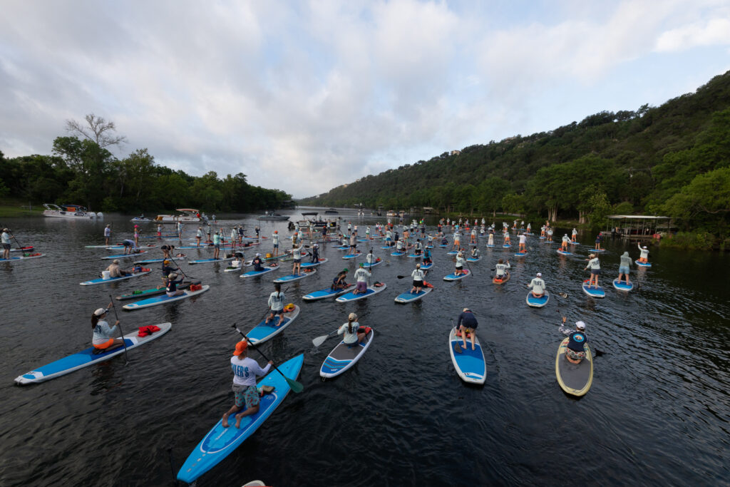 Paddlers take part in Flatwater’s 17th annual Dam That Cancer fundraiser on Lake Austin