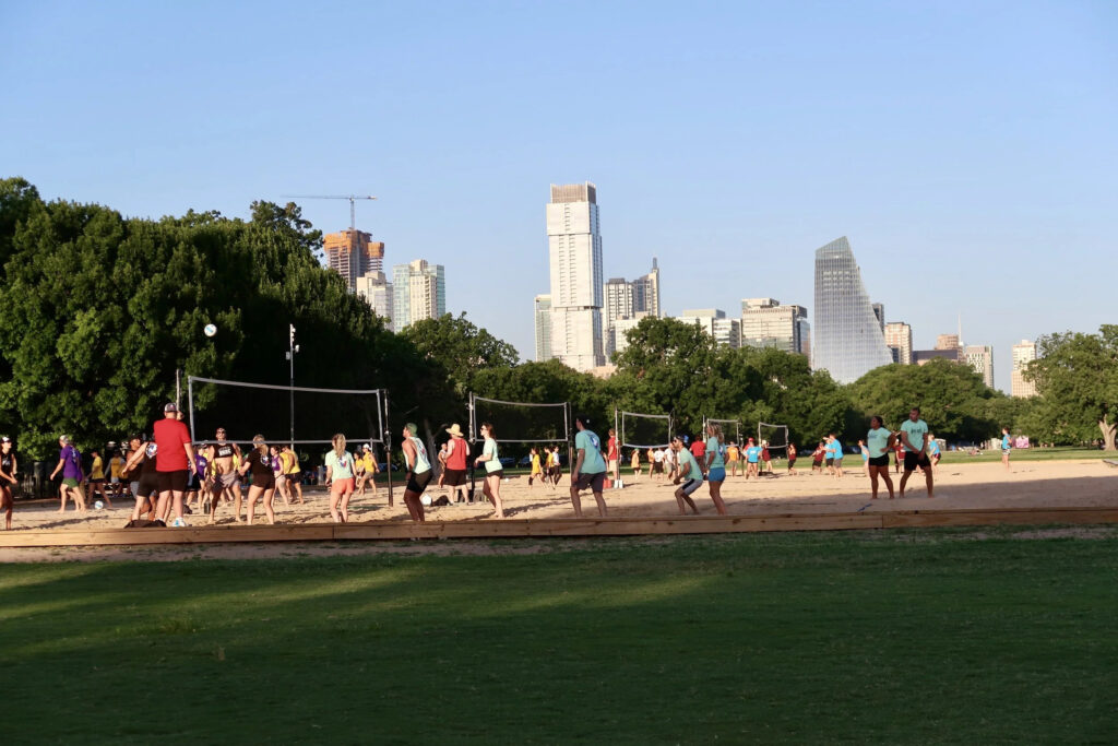 Players gather for a game of sand volleyball at Zilker Metropolitan Park in Austin.