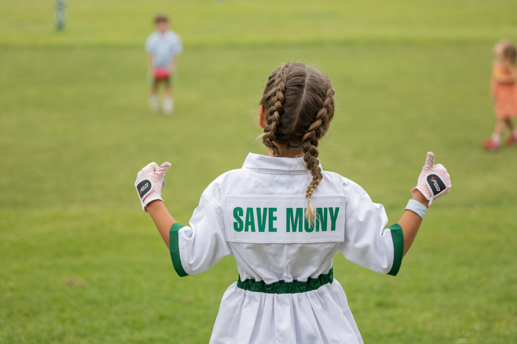 A child wears a “Save Muny” shirt during the Muny Cup and 19th Hole Party at Lions Municipal Golf Course in Austin on May 8.