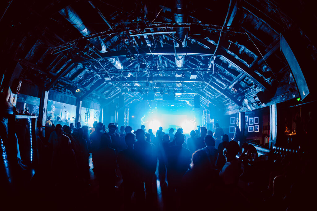 Crowds gather for a live music performance by Past Model at Elysium during Hot Summer Nights