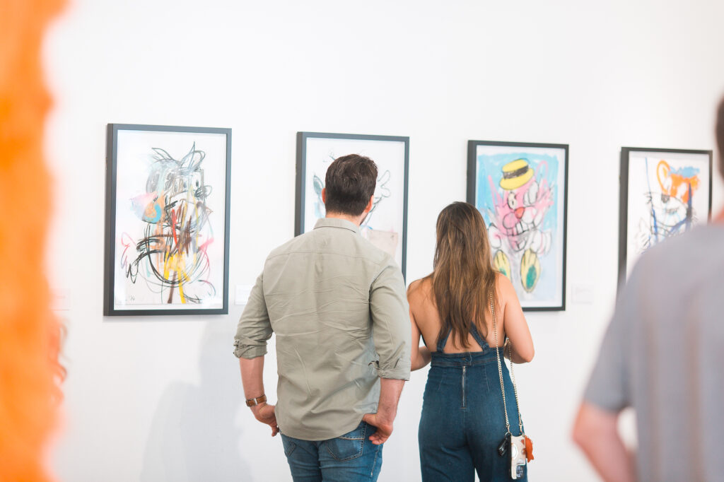 Guests view “Monsters,” a group exhibition now on view at West Chelsea Contemporary.