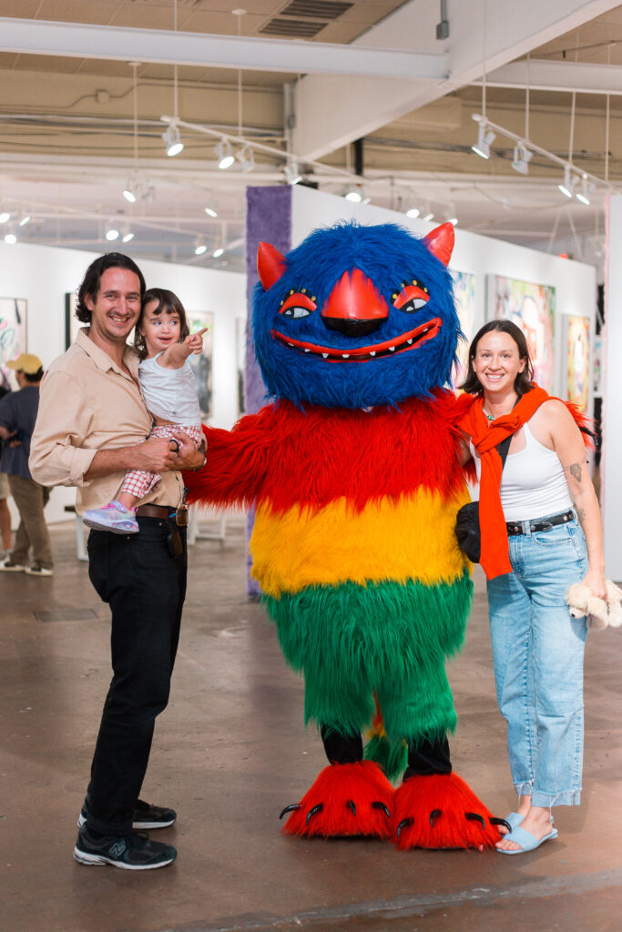 Guests pose with Mr. B Baby’s signature piñata-inspired character, “Chucho,” during the opening reception for “Monsters.”