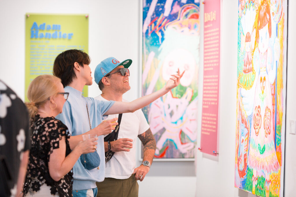 Guests view “Monsters,” a group exhibition now on view at West Chelsea Contemporary.