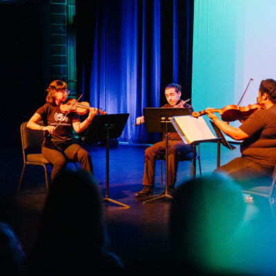 Austin Soundwaves string quartet of alumni and staff perform in the Rollins Studio Theatre (photo by Brynn Osborn). Focused on accessible and equitable music education, Austin Soundwaves was founded in 2011 by Dr. Teresa Lozano Long. They now have a fellowship in her honor.