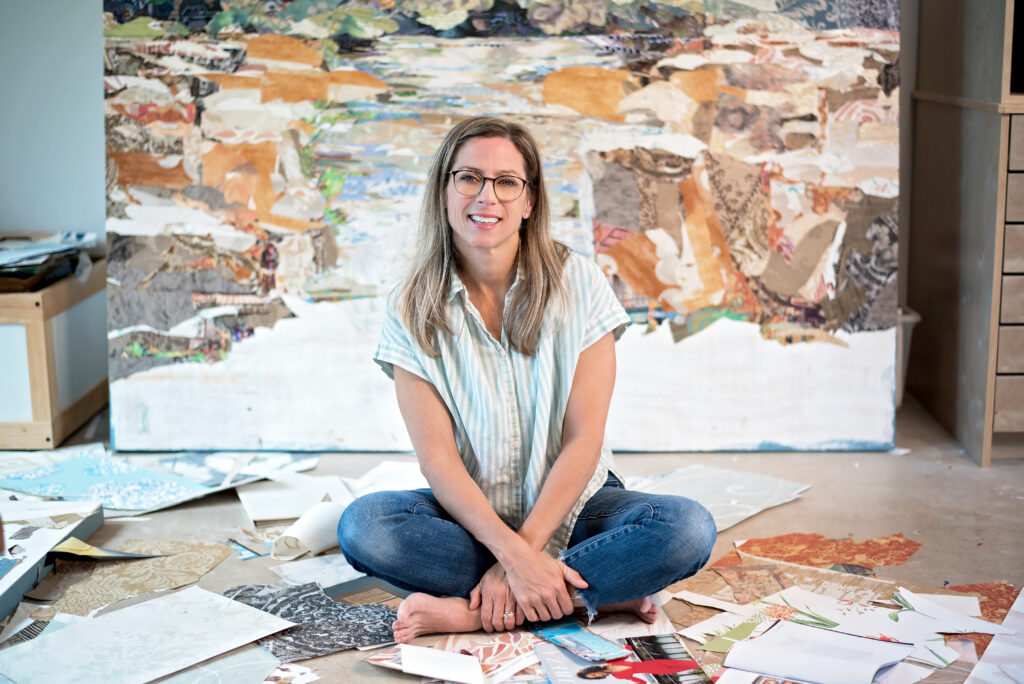 Artist Laurie Carswell poses with one of her layered paper collage works