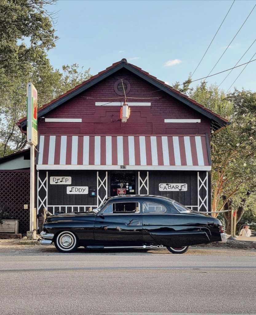 A 1951 Mercury coupe named for Mickey Hickman, one of Deep Eddy Cabaret’s original founders, is parked outside the longtime Austin bar.