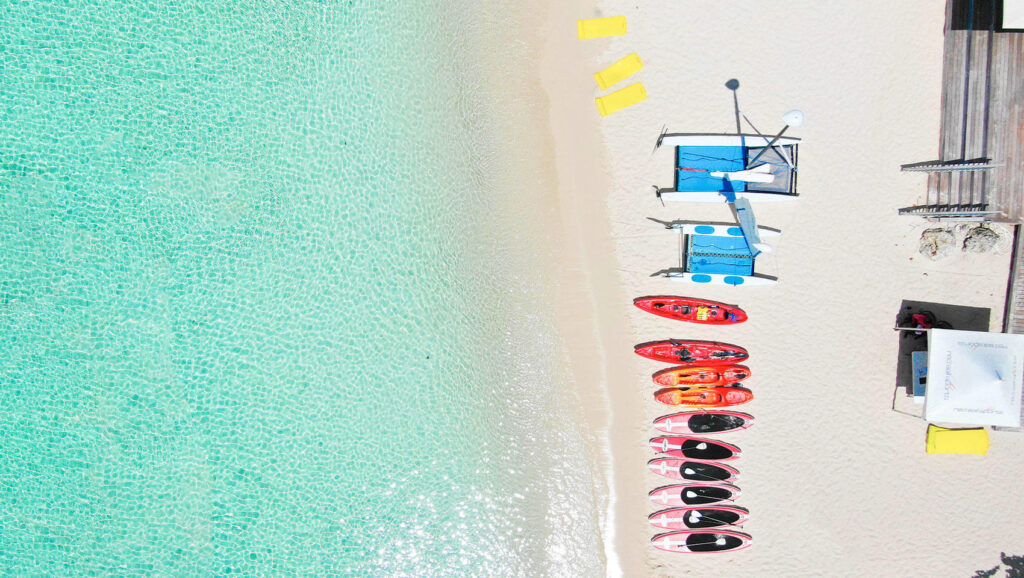 Carribean beach featuring kayaks and non-motorized watersports in Grand Cayman