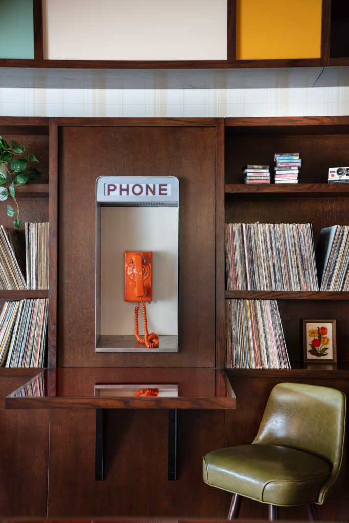 A vintage phone booth adds another nostalgic detail to the retro-inspired design.