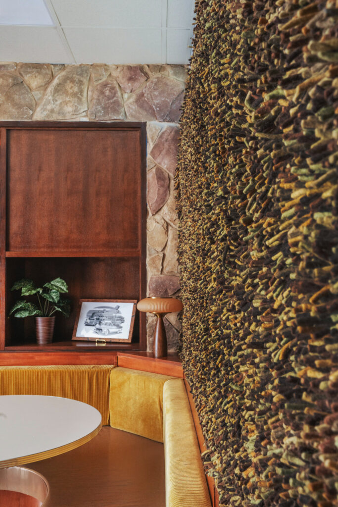 Shag carpet stapled to the wall adds a playful, budget-friendly 1970s touch