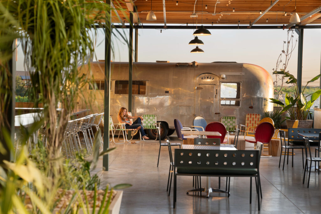 The outdoor patio at A Little Shady features Shady Grove’s original Airstream and a playful, summer camp-inspired design.