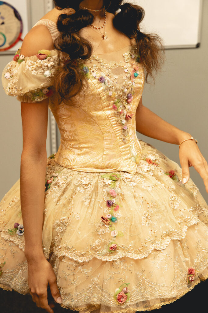 Ballet Austin’s peach Sugar Plum Fairy costume features soft ribbon detailing and rose-toned floral appliqué.