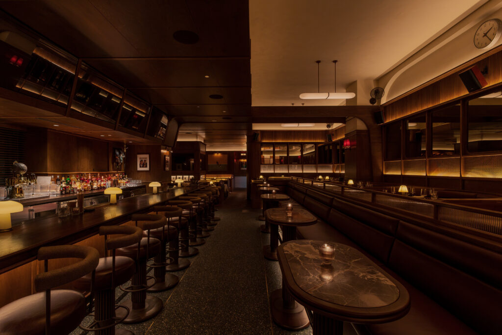 The main bar and dining room at Austin Sports Club feature custom millwork and cleverly concealed televisions. (Photo by Scene Select)