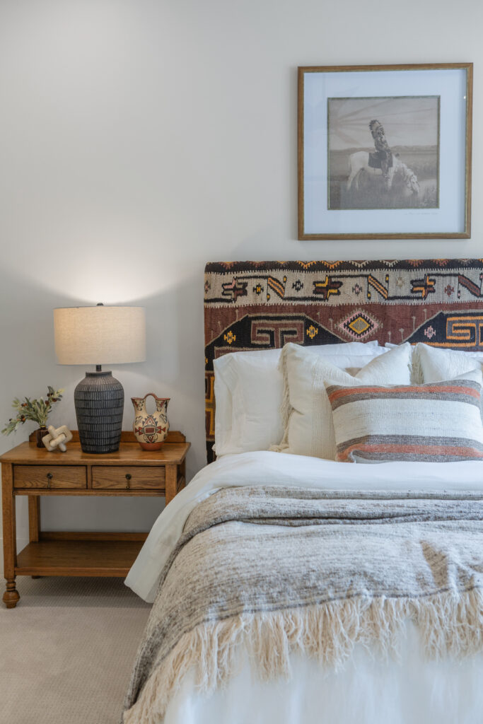 A kilim-upholstered headboard brings Southwestern color and texture to the guest bedroom. (Photo by Brittany Dawn Photography)