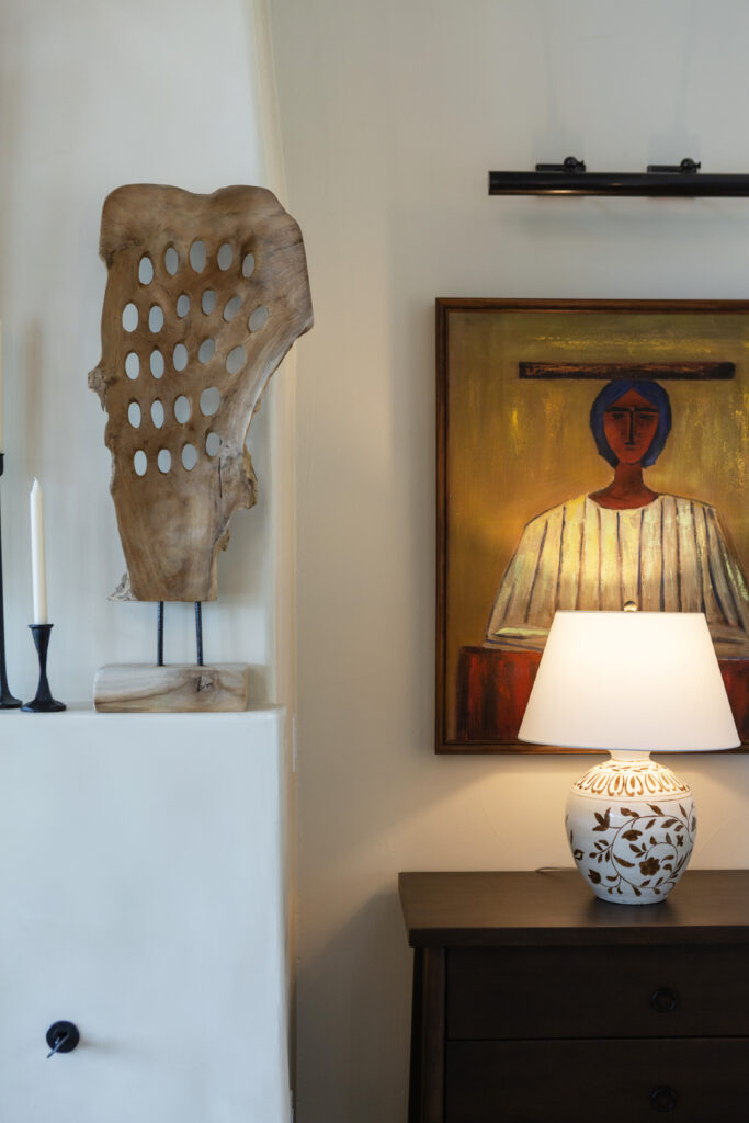 A carved wood sculpture and colorful portrait. (Photo by Brittany Dawn Photography)