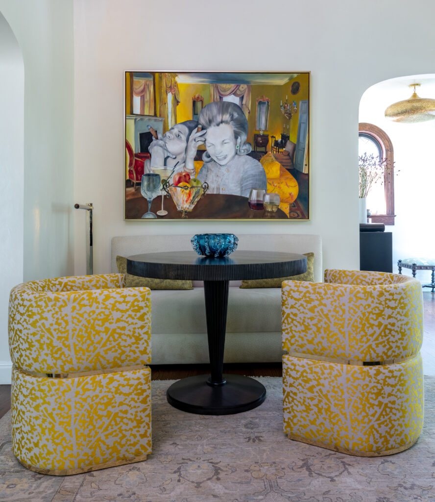 A colorful painting and yellow patterned chairs give this small seating area a playful feel. (Photo by Michael Hunter)