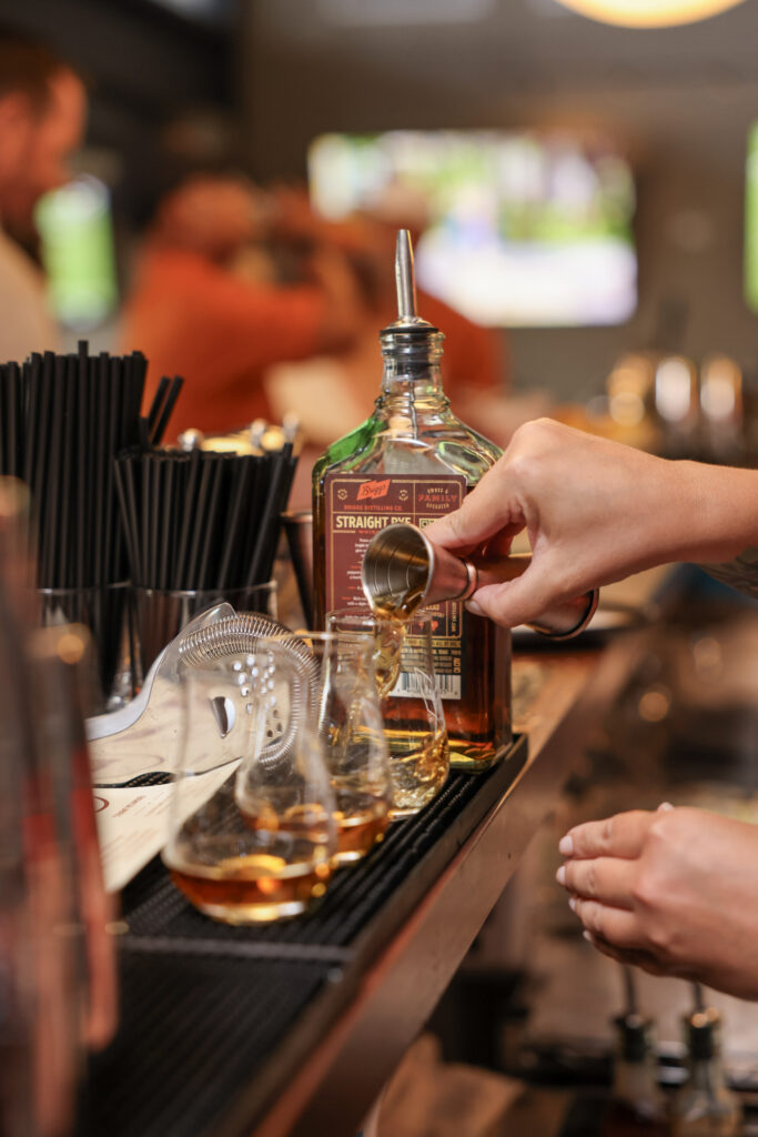 pouring whiskey at Briggs Distilling Co.