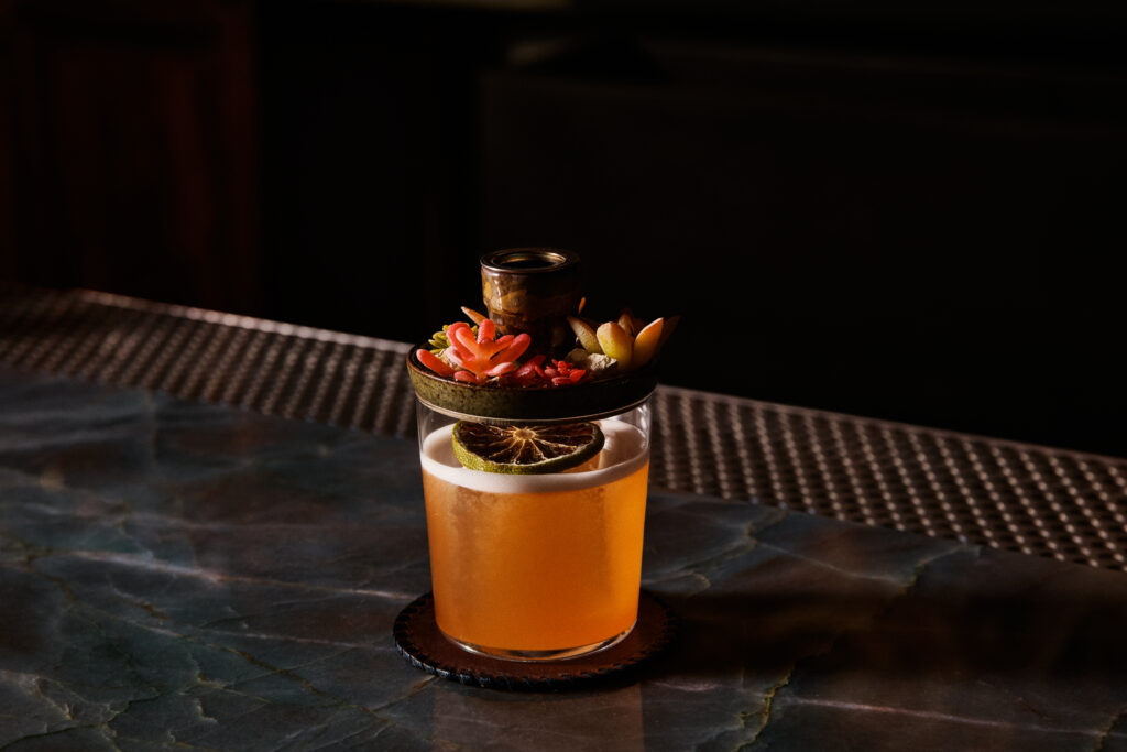 Escuela Fino’s Show & Tell cocktail is made with mezcal, peach, lime and habanero and smoked tableside.